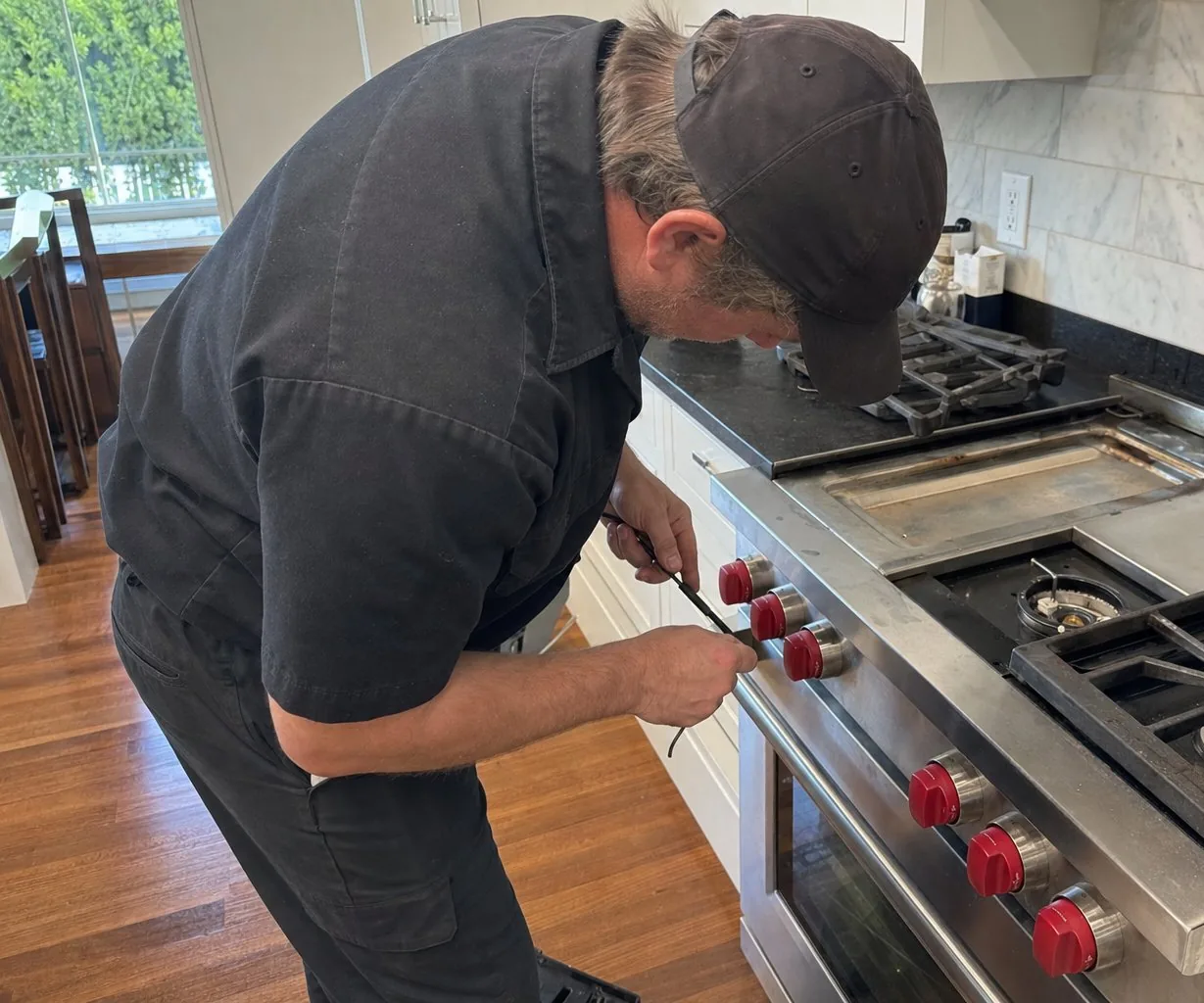 Technician servicing a stainless Wolf range on a same-day visit
